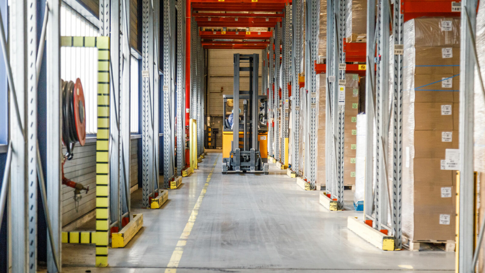 forklift driving through warehouse forklift driving through warehouse